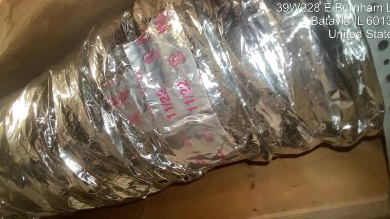 A cleaned flexible supply duct in an attic, foil jacket intact and the run straight