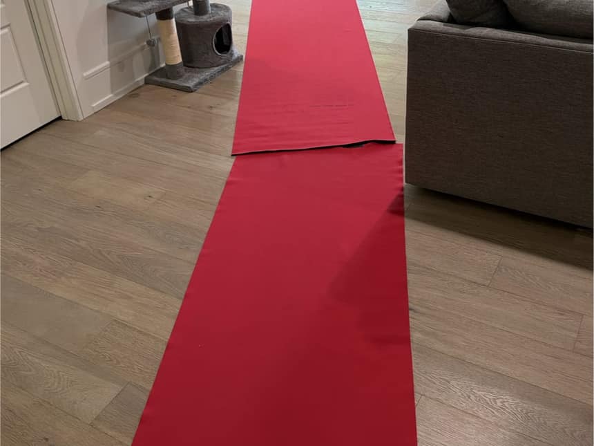 The Luxe Ducts red floor runner rolled from the front door across a living room floor before any equipment comes in